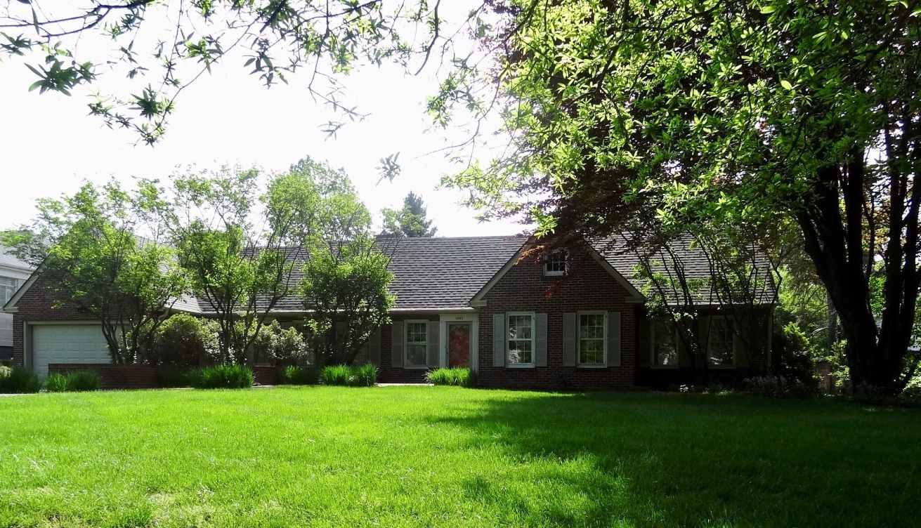 Lexington residential property with a large front lawn and mature trees